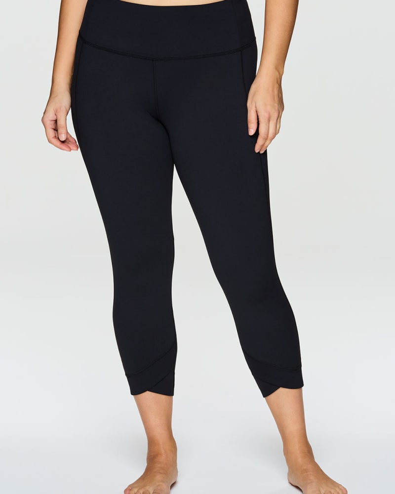 Front of a model wearing a size 1X Super Soft Tulip 7/8 Legging in Black by RBX Active. | dia_product_style_image_id:244915